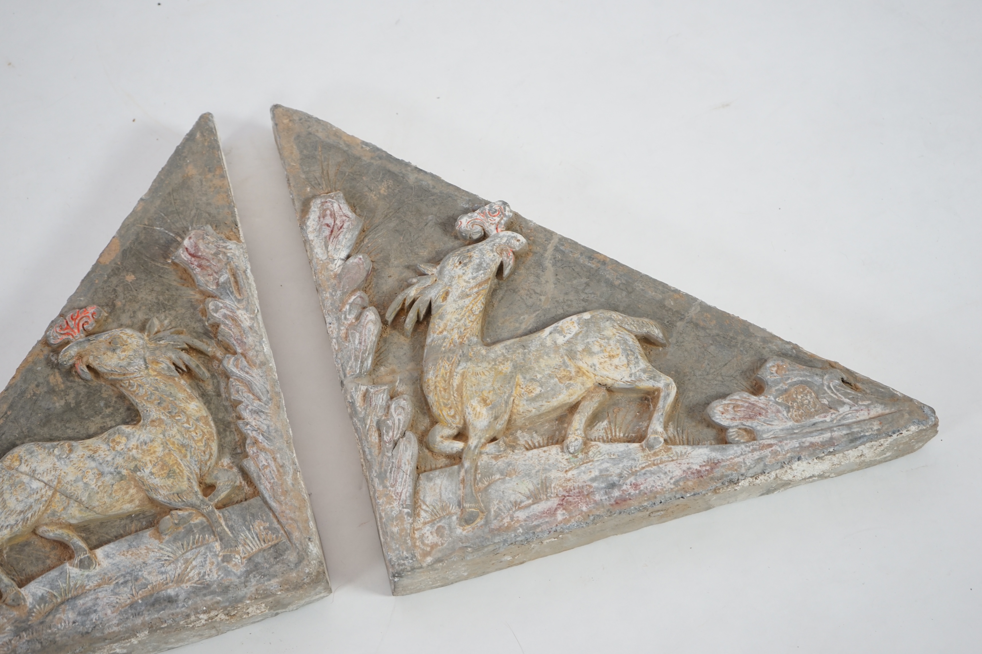 A fine pair of large Chinese painted pottery triangular tiles, Ming Dynasty (1368-1644)